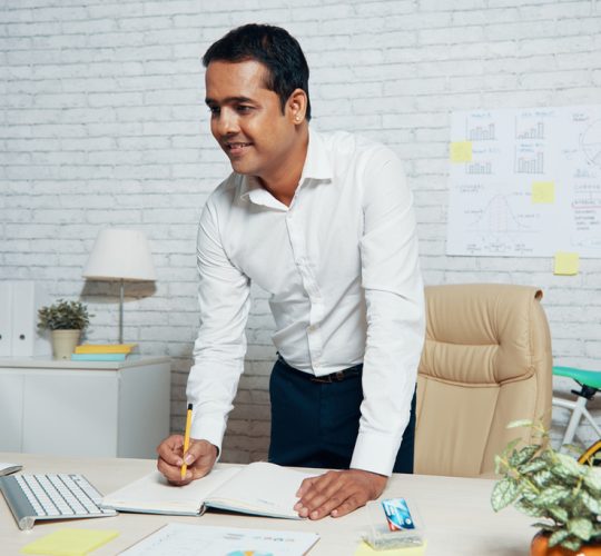 businessman-standing-his-desk-office