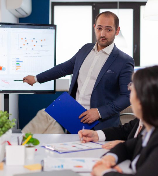 successful-team-leader-briefing-pointing-explaining-project-conference-room-brainstorming